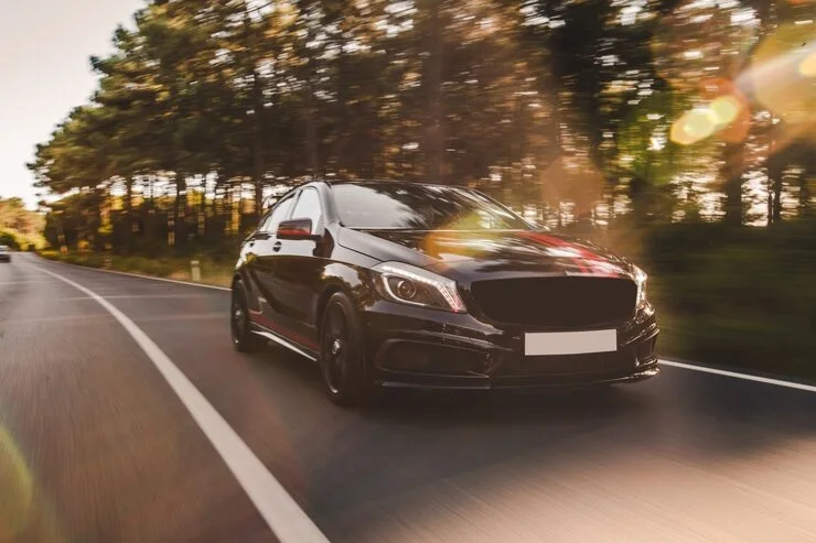 A car on a road in warm sunlight